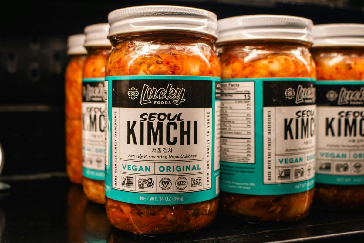 what foods are gut healthy – Assorted fermented foods like sauerkraut, yogurt, kimchi, and kombucha arranged on a wooden table